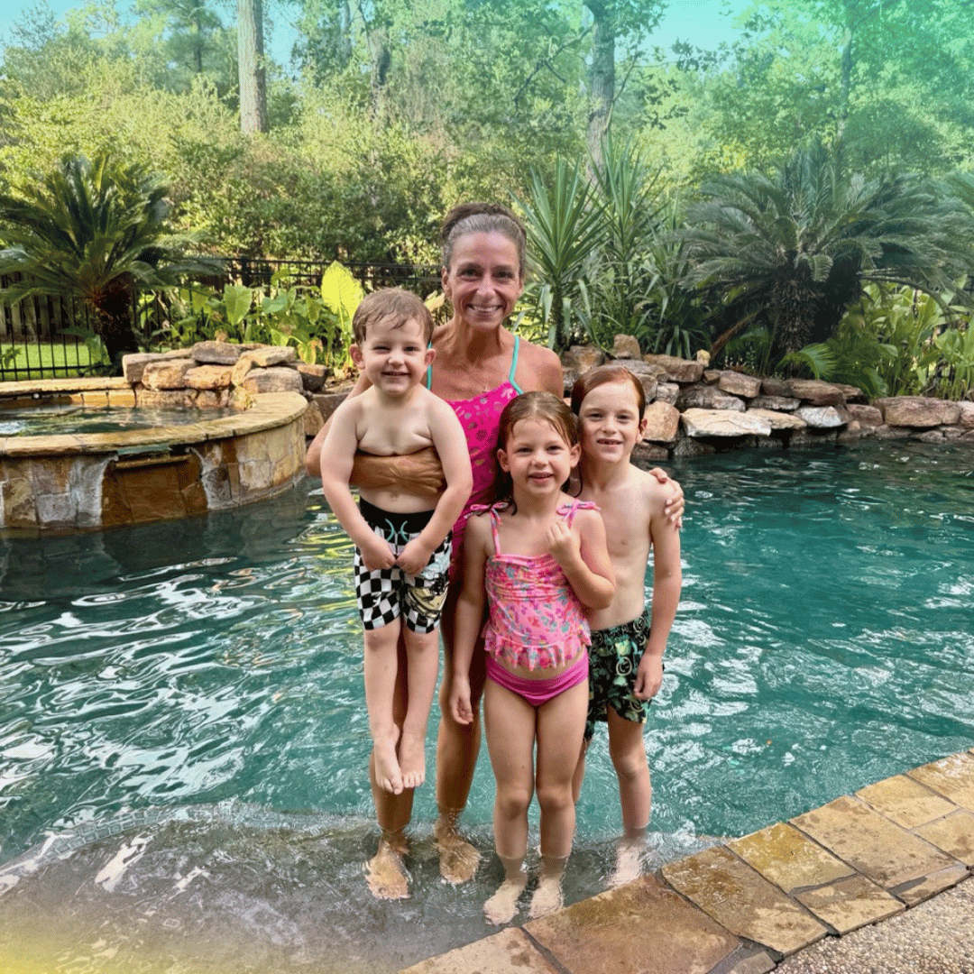 Nicole Ebert, Houston swim coach, poses with a group of young swimmers.